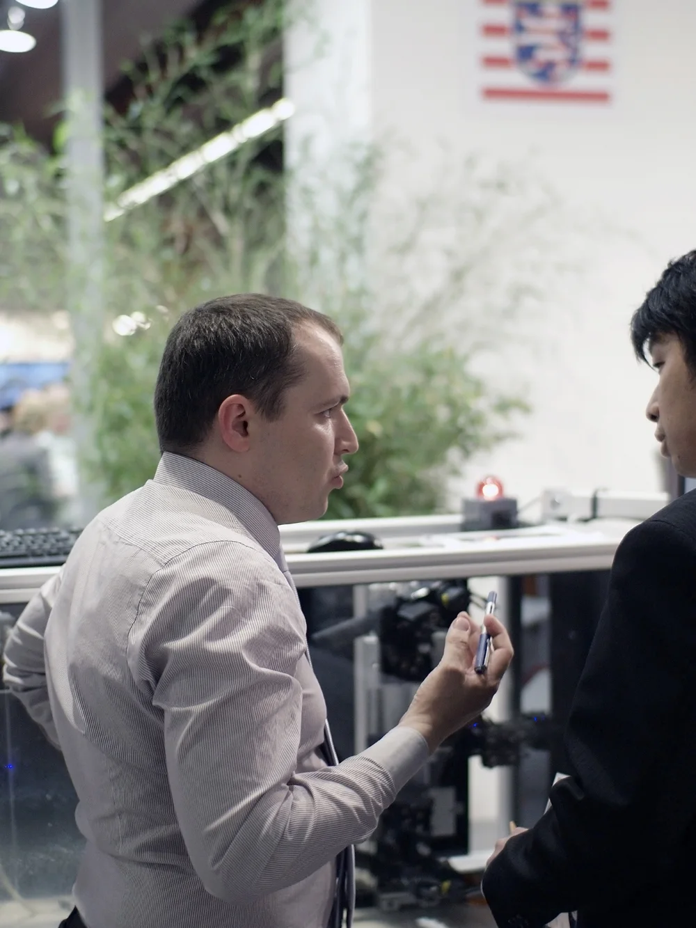 Walter Schäfer in conversation with a visitor at the ACHEMA 2012 stand